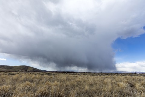 USA, Idaho, Picabo, Storm clouds over fields