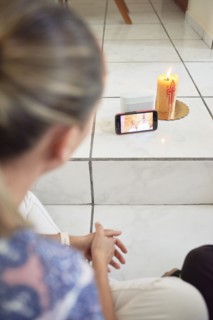 Woman attending mass on cellphone