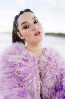 Belarus, Minsk, Outdoor portrait of young woman in pink fur coat
