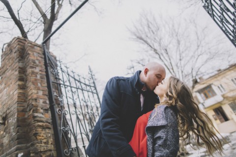 Newlywed couple kissing on street