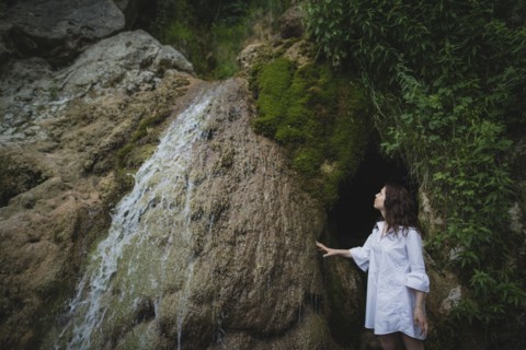 Ukraine, Crimea, Young woman standing by waterfall