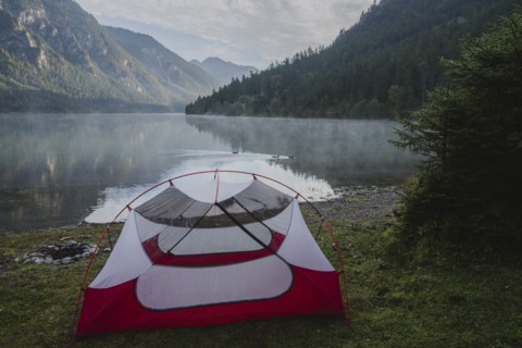 Austria, Plansee, Tent by lake Plansee in Austrian Alps at sunrise