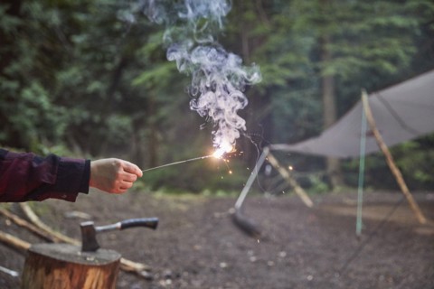 Orcas Island, Man holding sparkler at camping