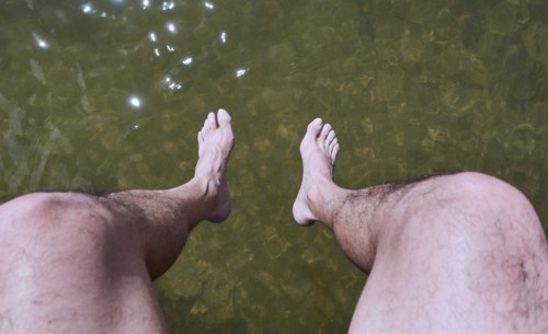 Man sitting above water