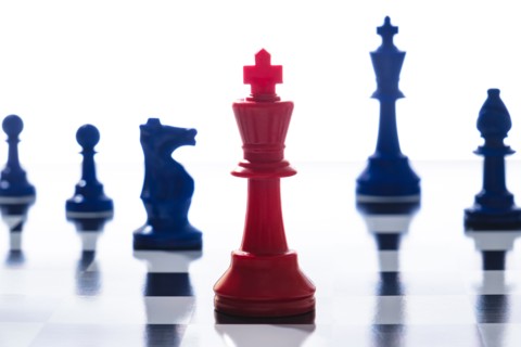 Studio shot of red and blue chess pawns symbolizing US Democratic and Republican parties