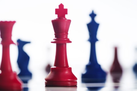 Studio shot of red and blue chess pawns symbolizing US Democratic and Republican parties