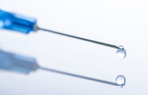 Liquid drop on top of syringe needle