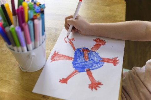 Girl (6-7) drawing coronavirus