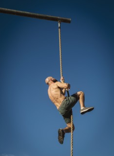 Man climbing on rope