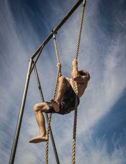 Man exercising on rope
