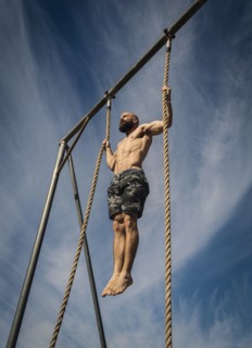 Man exercising on rope