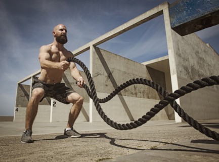 Man exercising with ropes
