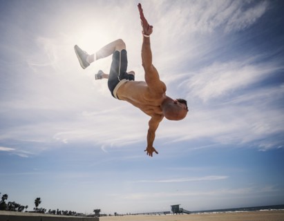 Muscular man exercising on beach