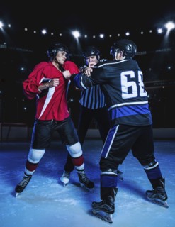 Referee separating fighting hockey players