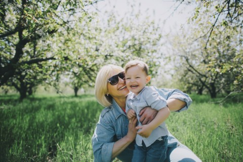 Mother with son (2-3) in orchard