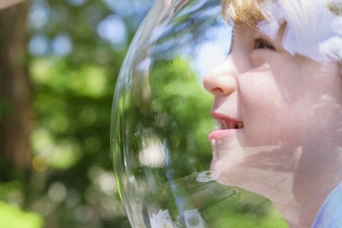 Boy wearing bubble outdoors to socially distance