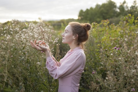 Russia, Omsk, Young woman in meadow