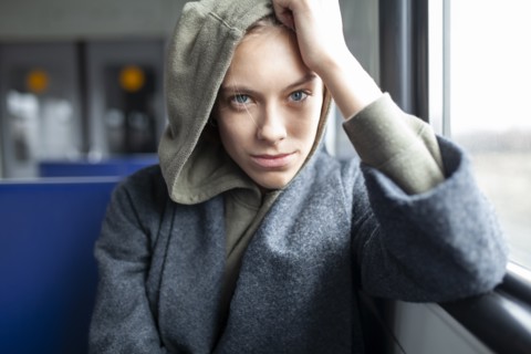 Portrait of young woman in train