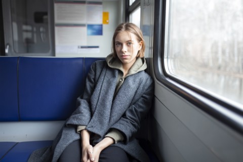 Portrait of young woman in train