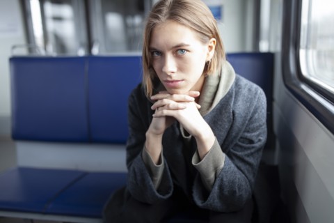 Portrait of young woman in train