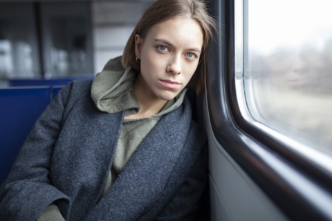 Portrait of young woman in train
