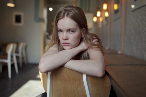 Portrait of young woman with long blond hair