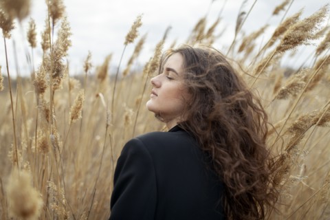 Young woman in tall grass