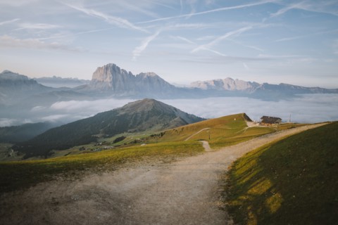 Italy, Dolomite Alps, Scenic view of small village in Dolomites at sunrise