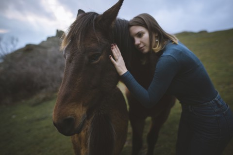 Ukraine, Crimea, Young woman embracing Icelandic horse
