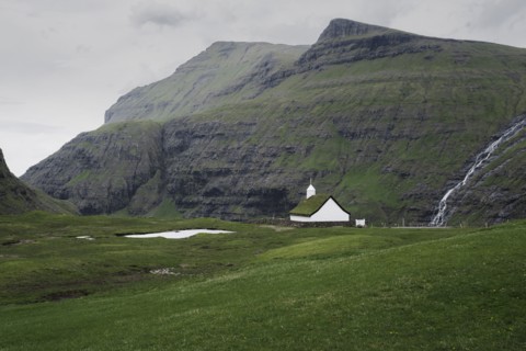 Denmark, Small church in green landscape with mountains,