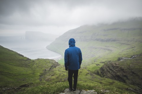 Denmark, Man standing on cliff above sea and looking at view,