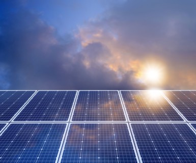 Sun and clouds reflecting in solar panel,,