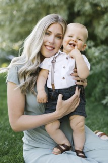 Outdoor portrait of smiling mother with baby son