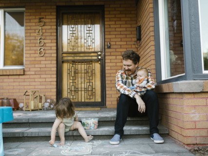 Father with kids sitting on porch