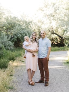 Family with baby boy (12-17 months) standing in park