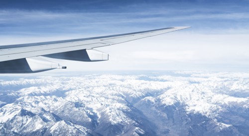 Switzerland, Canton Wallis, Airplane wing over snowy mountains