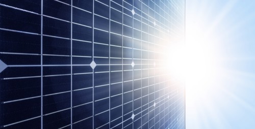 Sun shining over solar panel