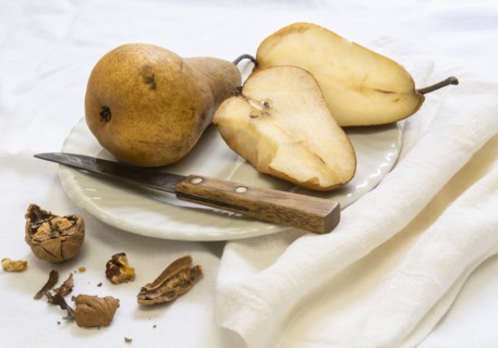 Sliced pear and knife on plate