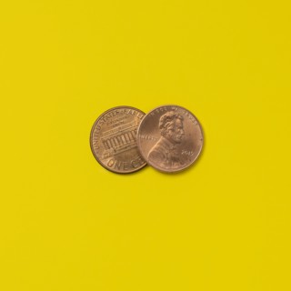 Front and back of two pennies on yellow background