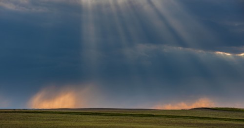USA, South Dakota, Storm clouds at sunset over prairie
