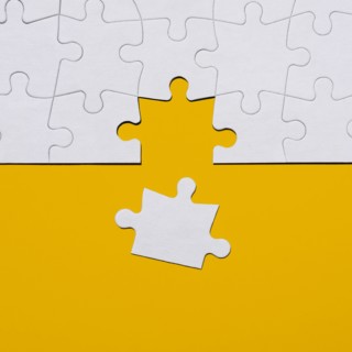 Last puzzle piece in jigsaw puzzle on yellow background