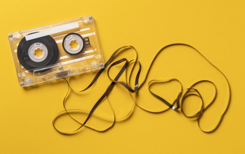 Analog audio cassette on yellow background