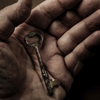 Hand holding antique key