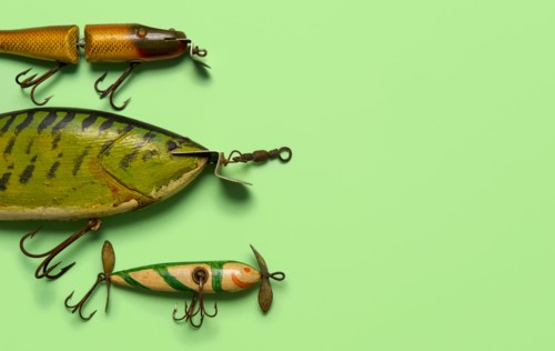 Antique fishing lures on green background