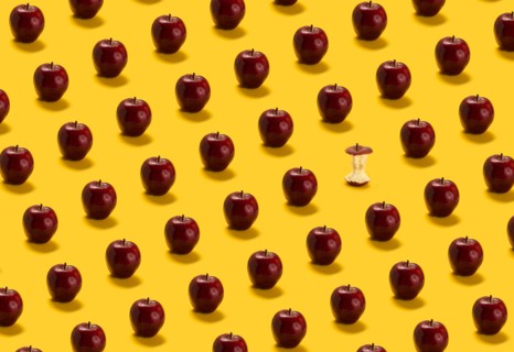 Large group of red apples on yellow background