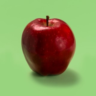 Red apple against green background