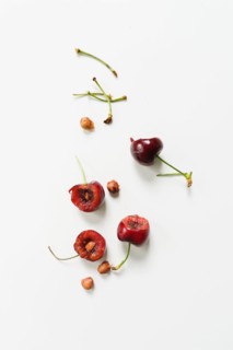 Eaten cherries on white background
