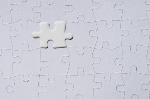White jigsaw piece on jigsaw pattern