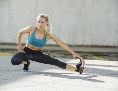 Sporty woman stretching outdoors