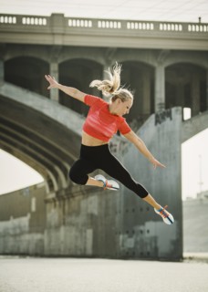 USA, California, Los Angeles, Sporty woman jumping in urban setting